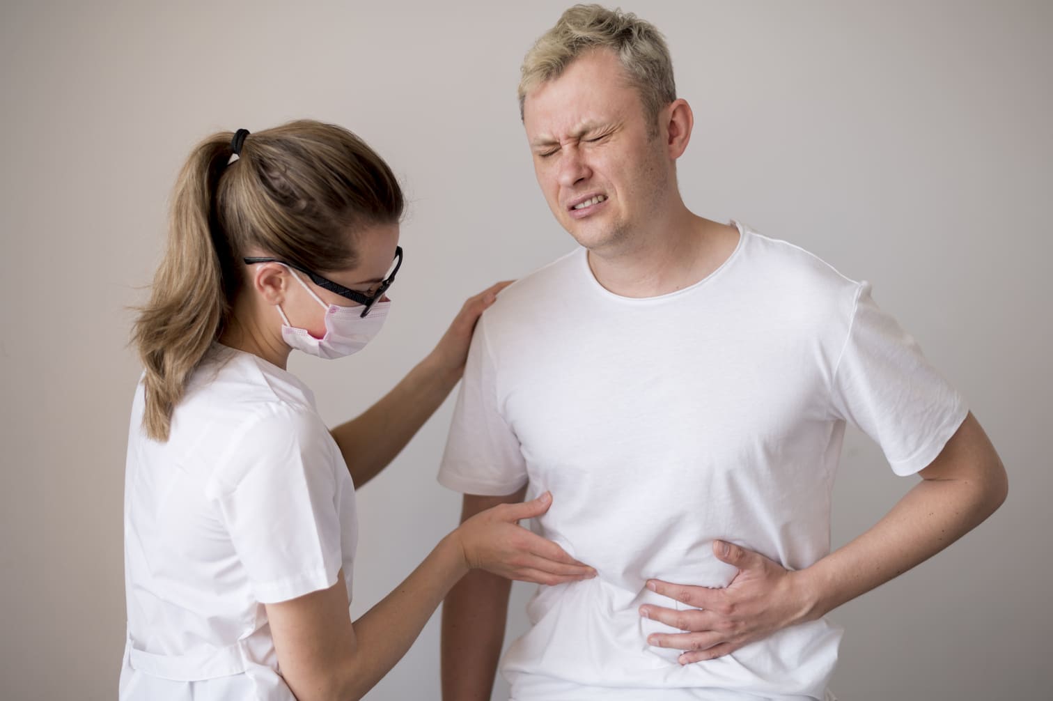 Doctor checking patients stomach