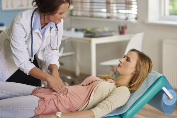 Doctor checking patients stomach for hiatal hernia