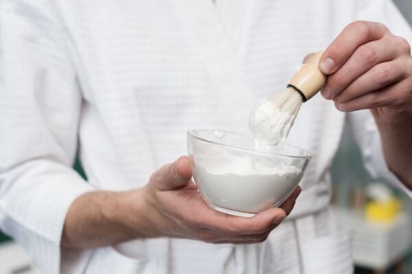 Person holding a bowl of baking soda