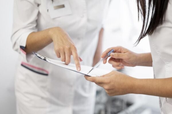 Doctor & Gastroparesis patient looking at hardboard