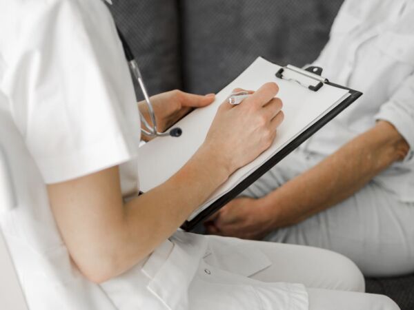 Doctor writing hiatal hernia procedure on his clipboard
