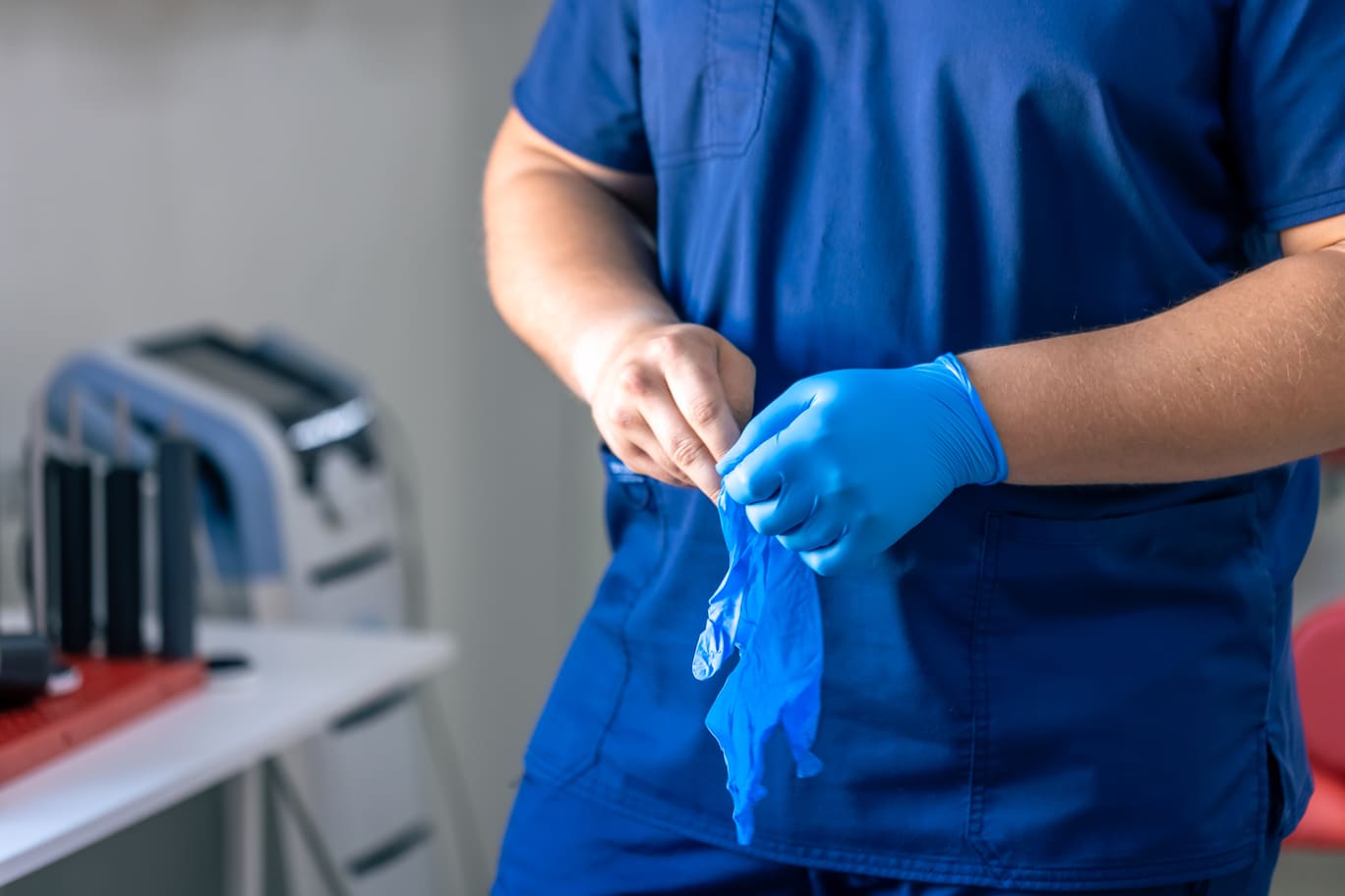 Doctor putting gloves before surgery