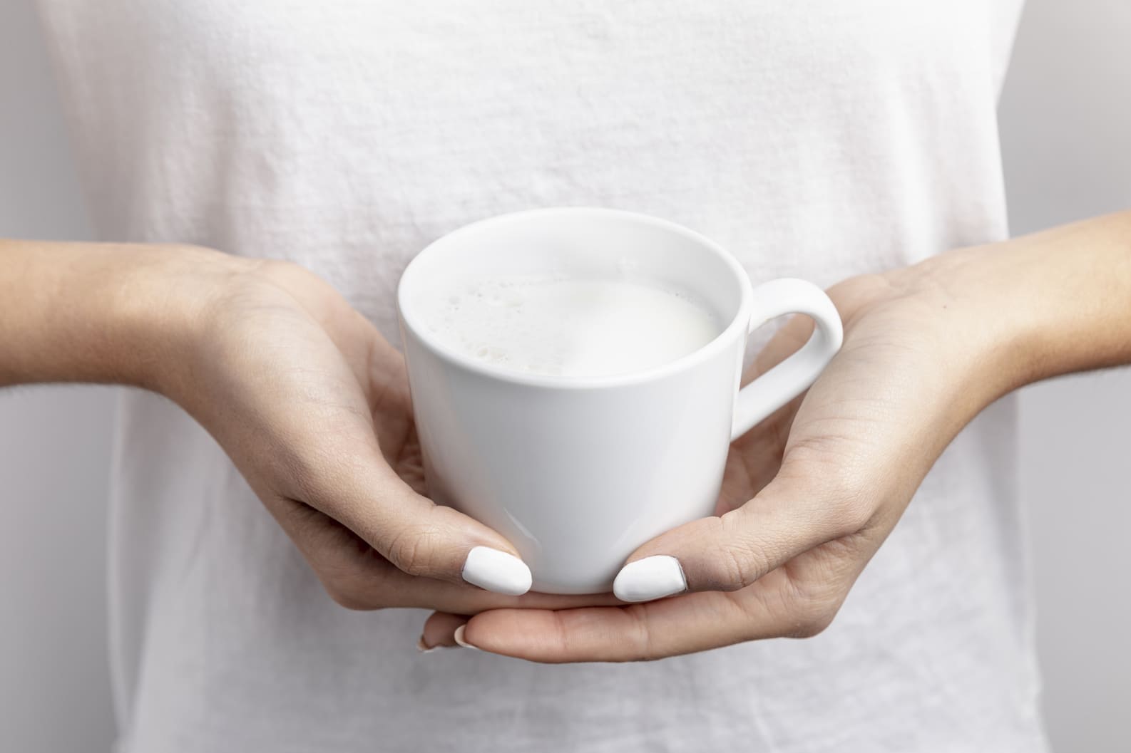 Heartburn patient holding a cup of milk
