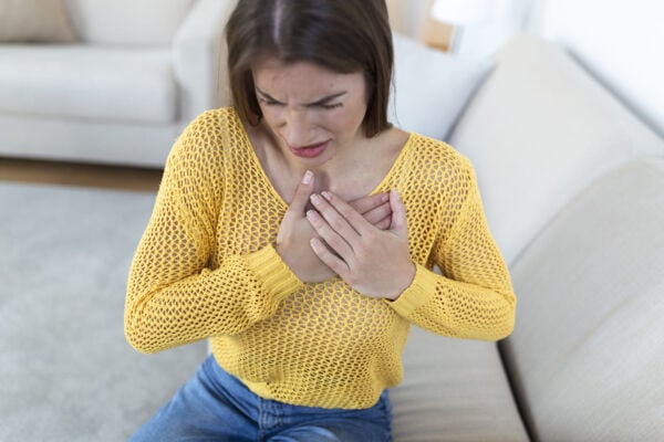 Women with heartburn holding her chest