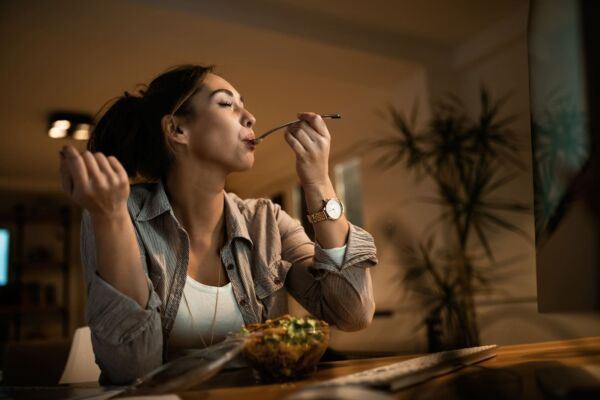 Woman with heartburn eating
