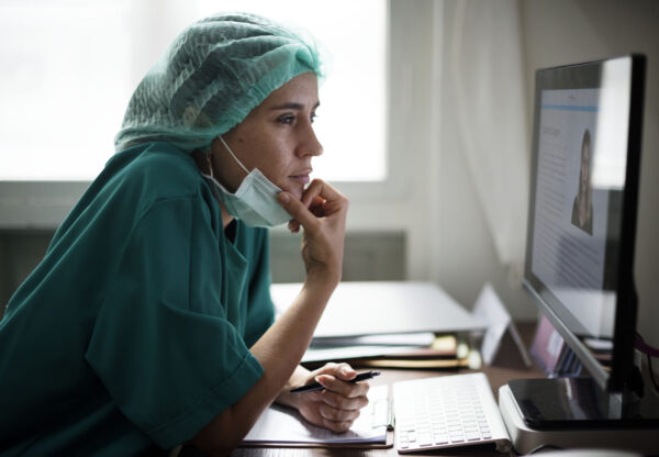Gastroenterologist looking at patients profile in a computer