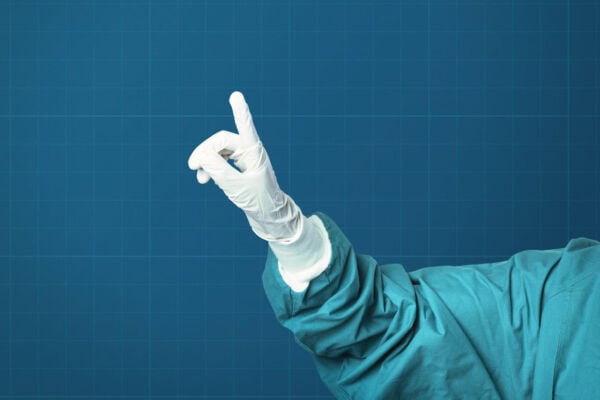 Hand in medical glove showing index finger
