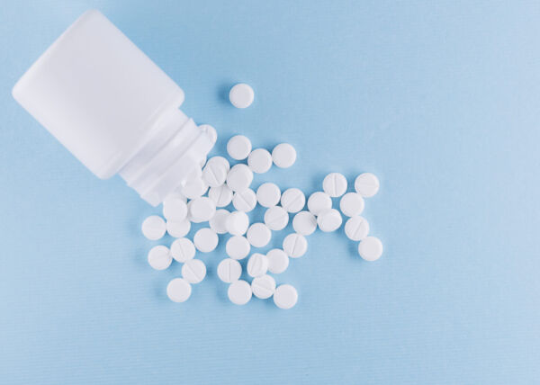 White pills in a plastic bottle