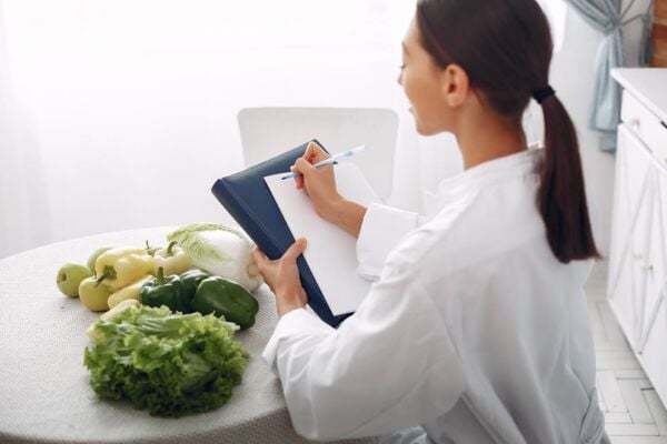 Doctor looking at vegetables and listing them