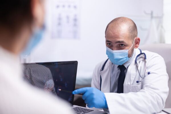 Doctor showing patients diagnosis on a tablet