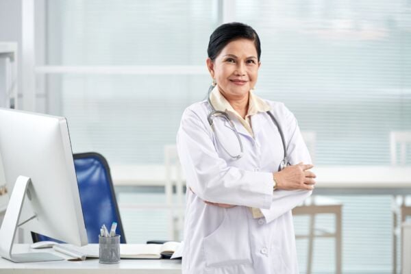 Heartburn doctor in her office smiling