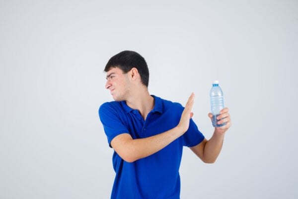 Man with heartburn avoiding water