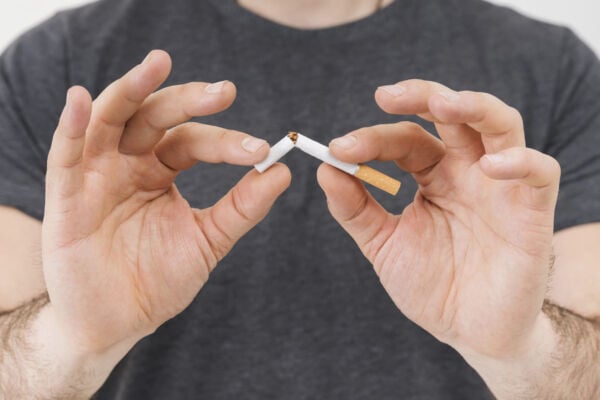 Man with hiatal hernia breaking cigarette