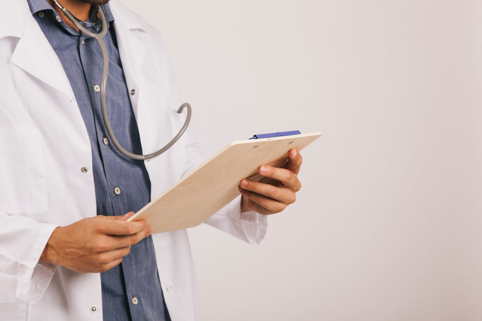 Doctor reading clipboard of gastroparesis patient