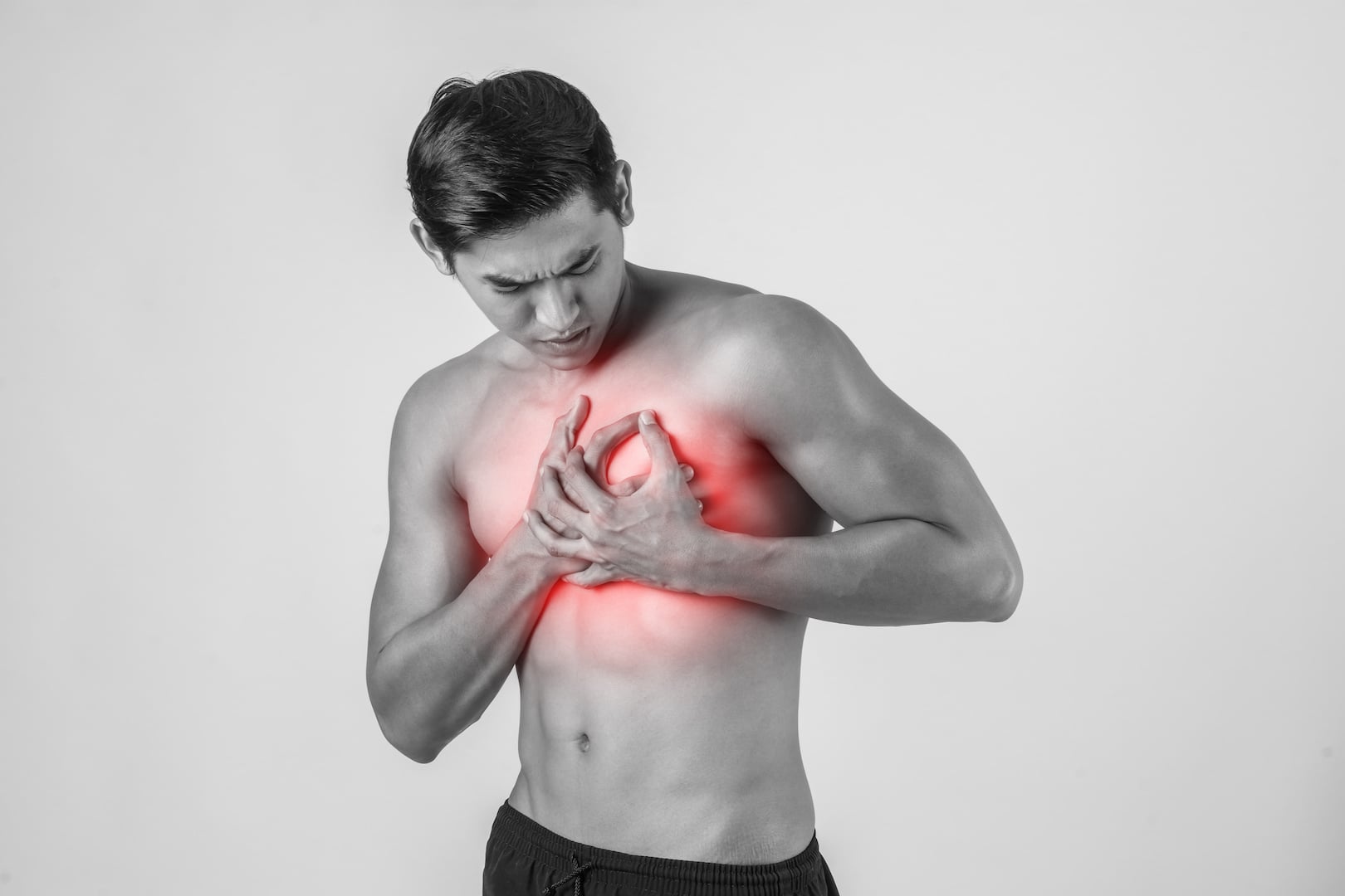 Man holding chest wondering if its heartburn