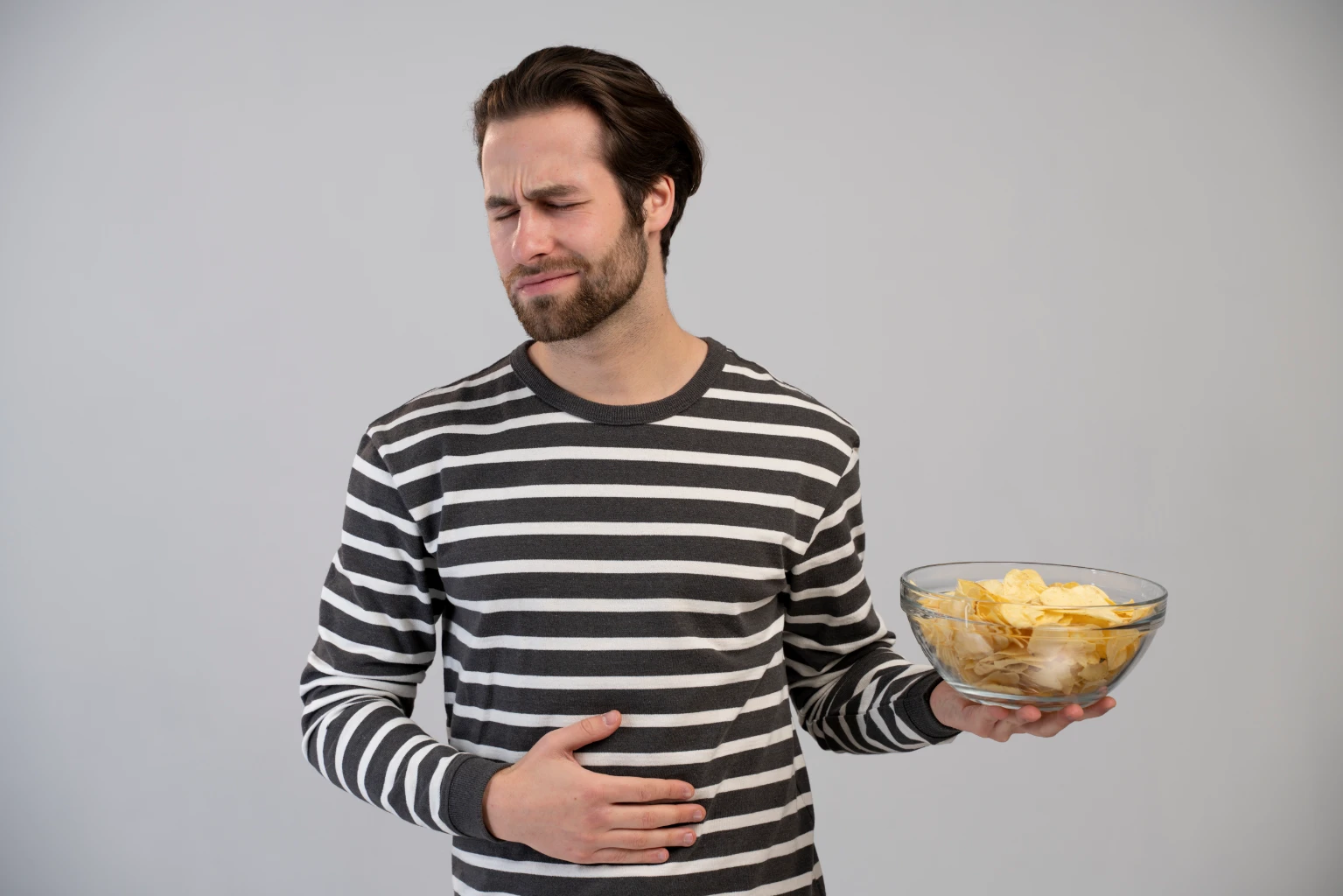 Man with gastroparesis in pain because of unhealthy food