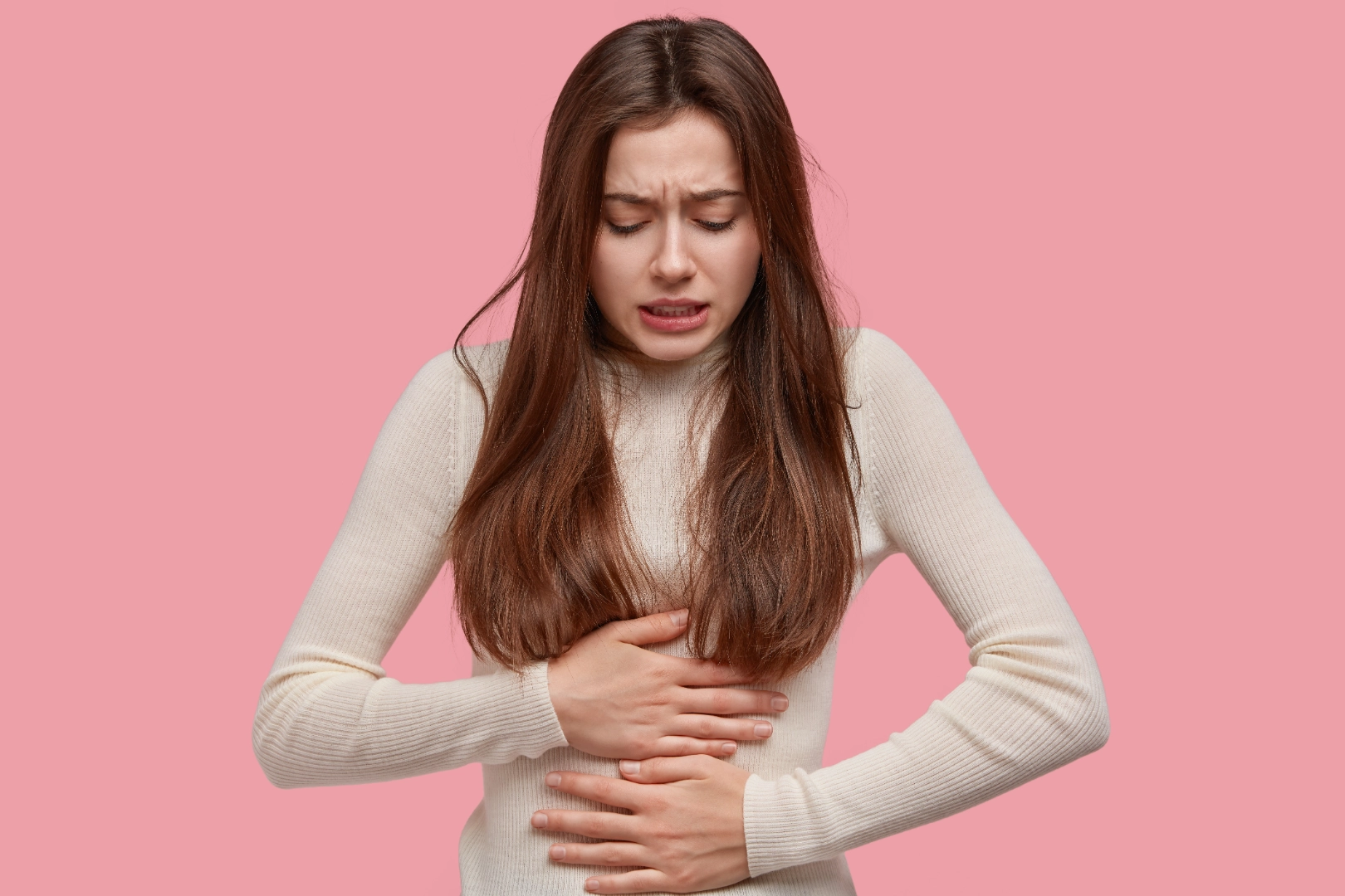 Woman with acid reflux holding her chest