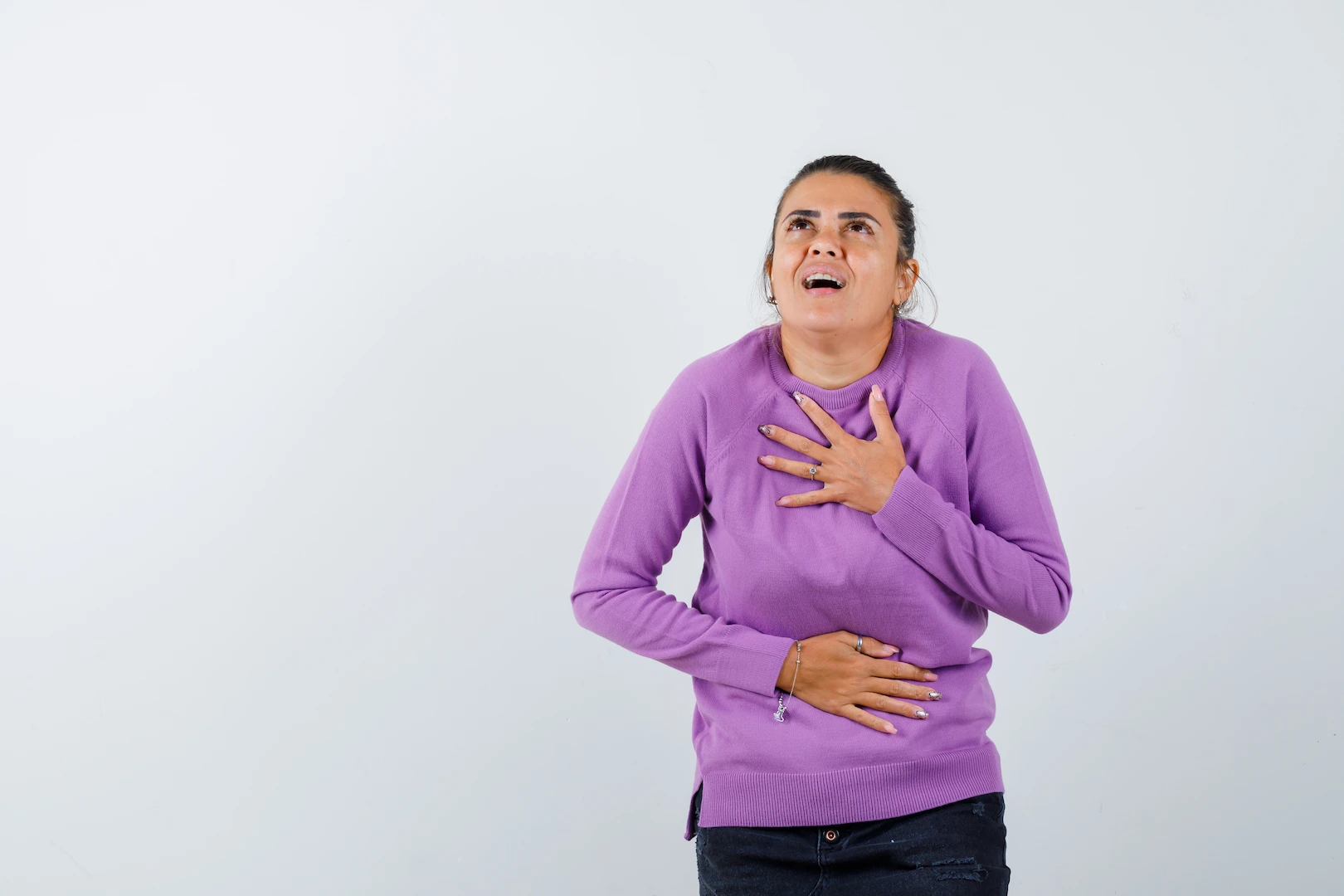Woman with heartburn holding chest and stomach