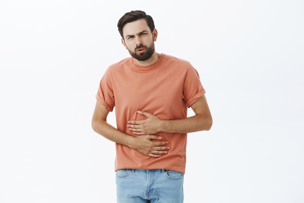 Man with gastroparesis both hands holding stomach