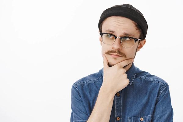 Man with hiatal hernia holding chin wondering