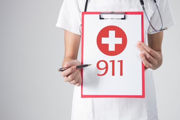 Nurse holding a clipboard with 911 writing
