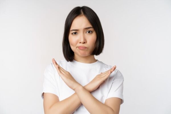 Woman making stop gesture for GERD trigger avoidance