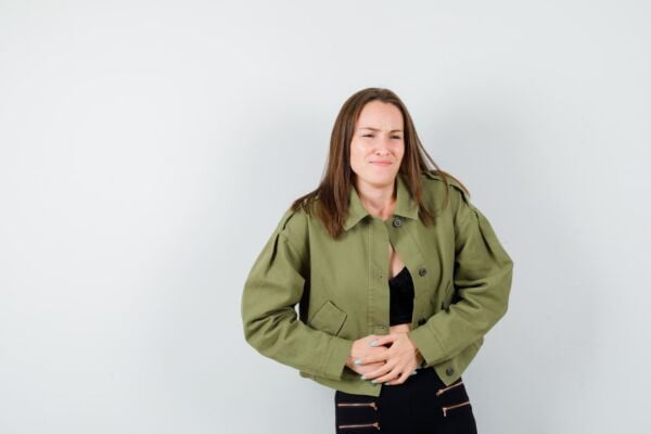 Woman with hiatal hernia in pain holding her stomach