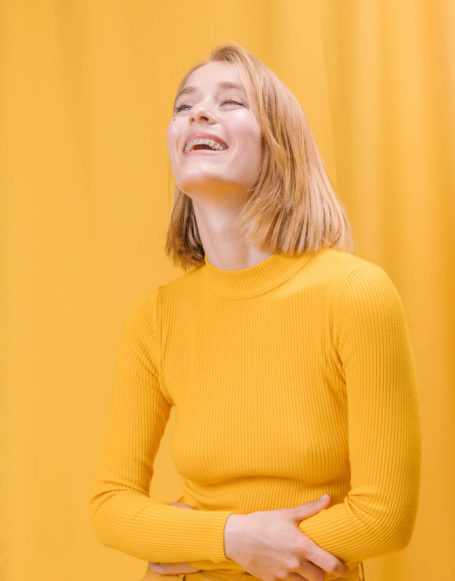 Women smiling while holding stomach