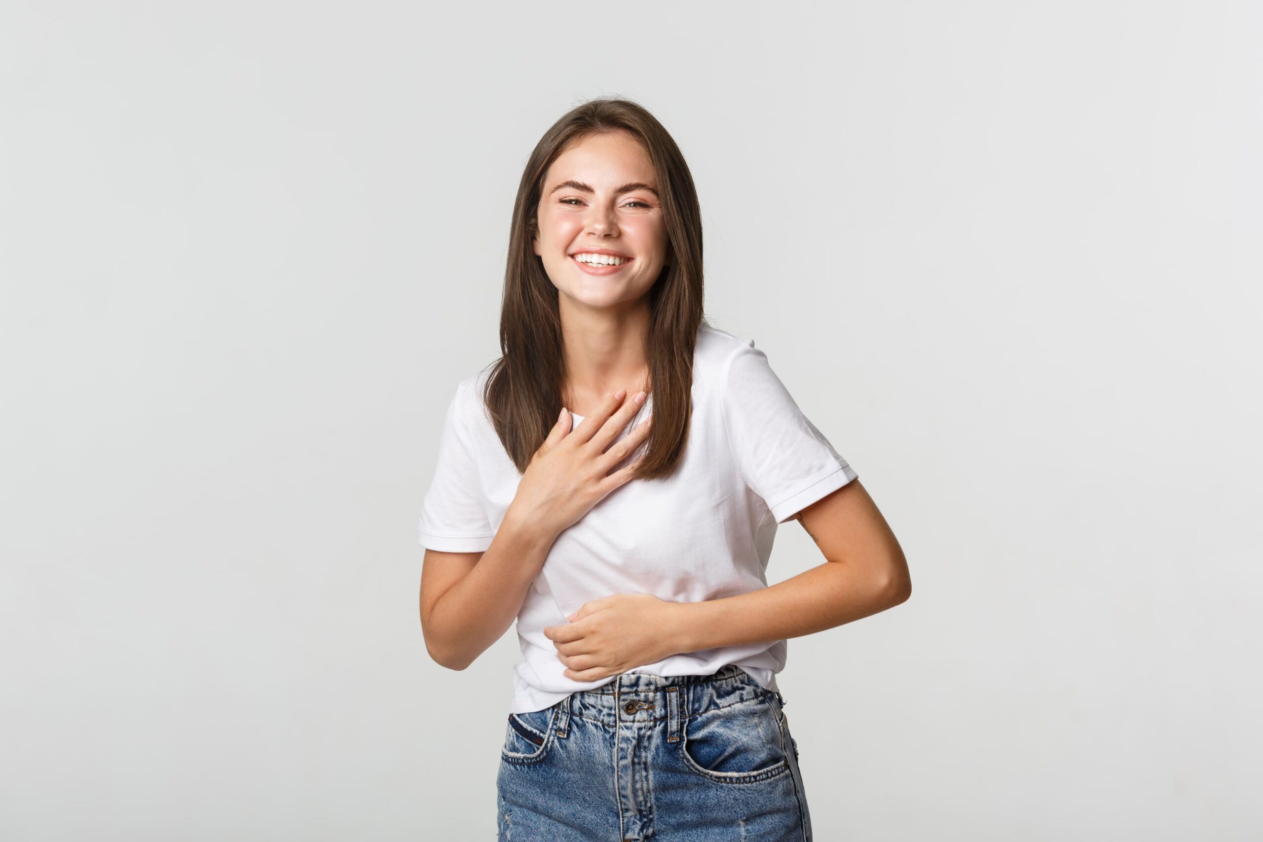 Women with hiatal hernia smiling while holding chest Women with hiatal hernia smiling while holding chest