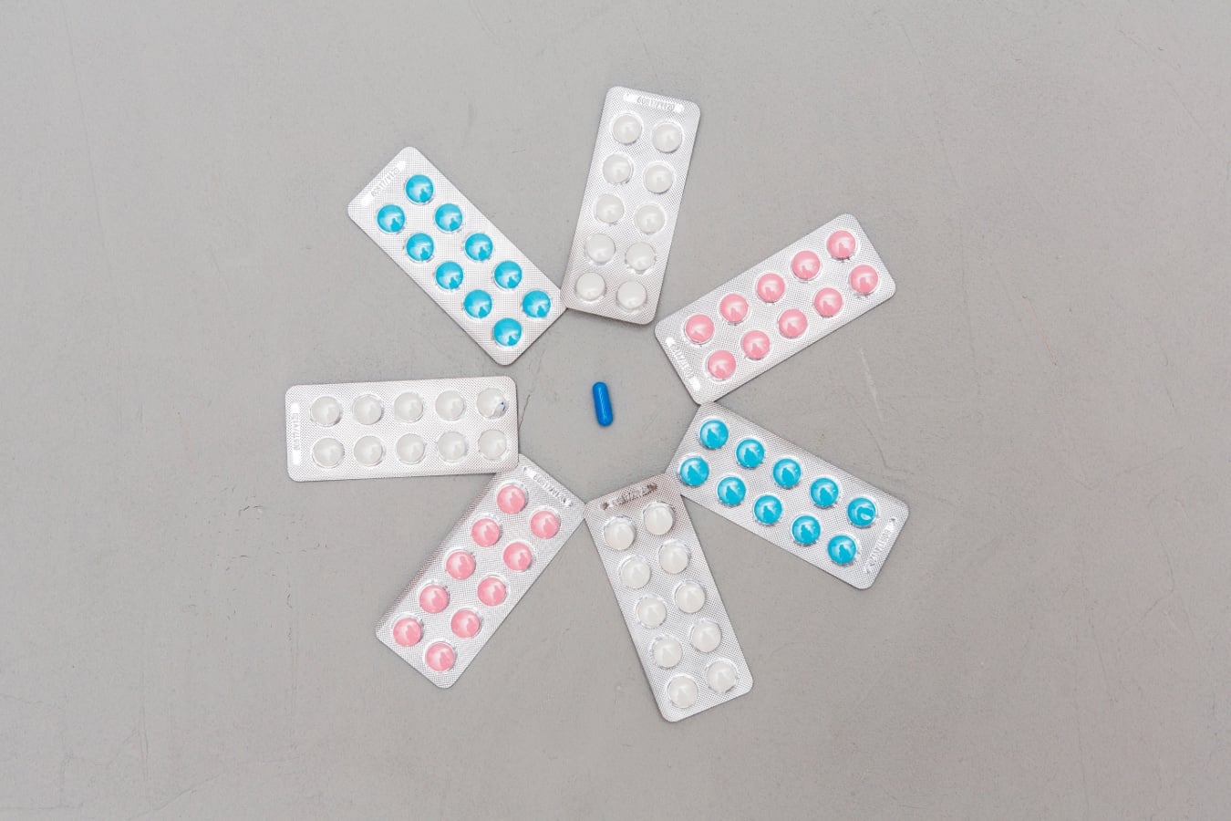 Assorted medication blister packs arranged in a circular pattern