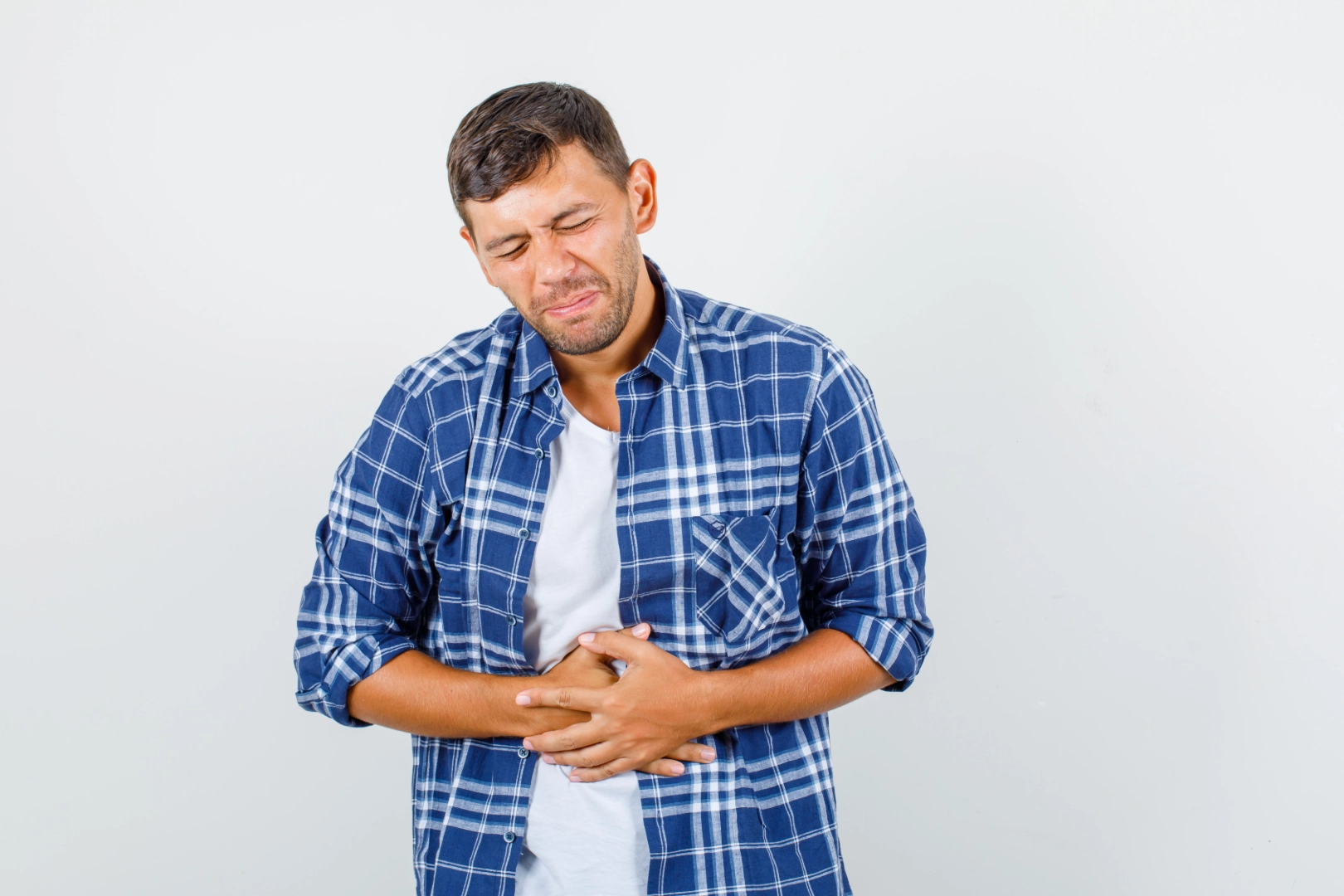 Man with gastroparesis in pain holding stomach