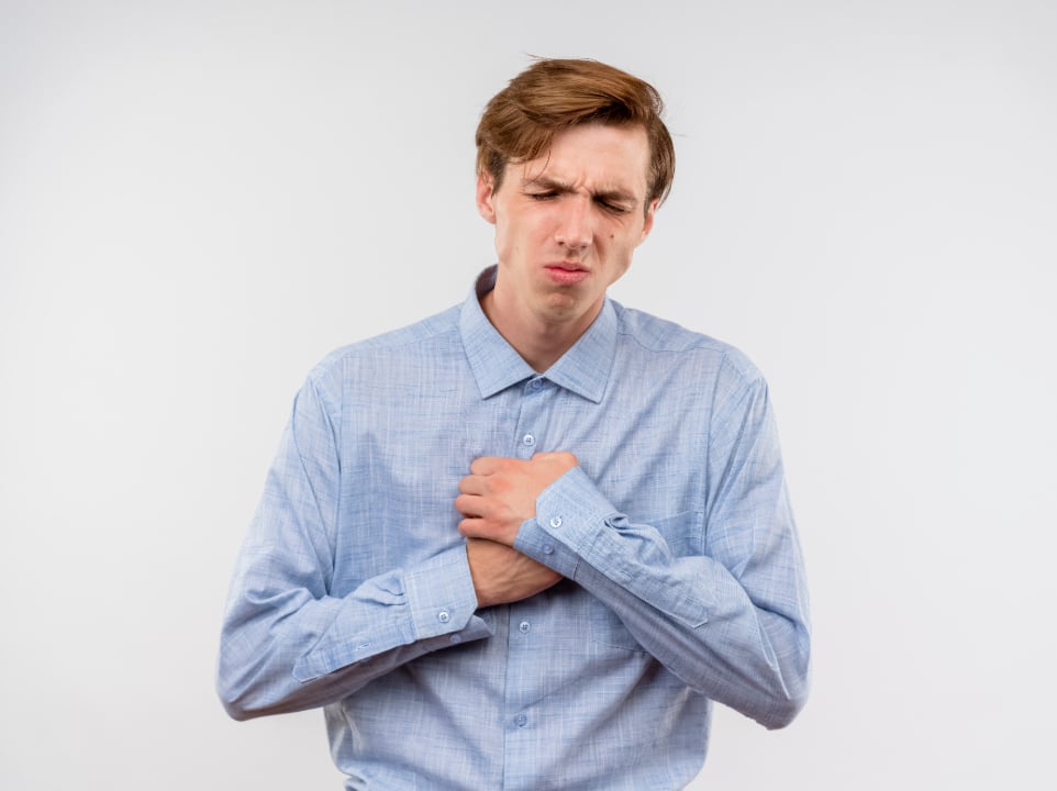 Man with hiatal hernia tightly holding chest