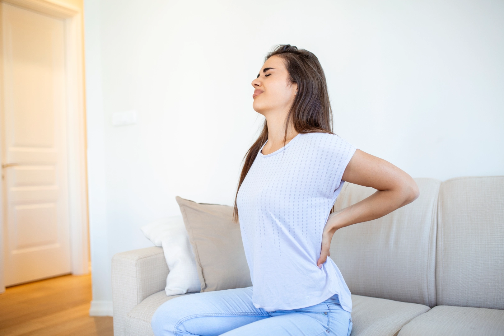 Woman having back pain because of hiatal hernia
