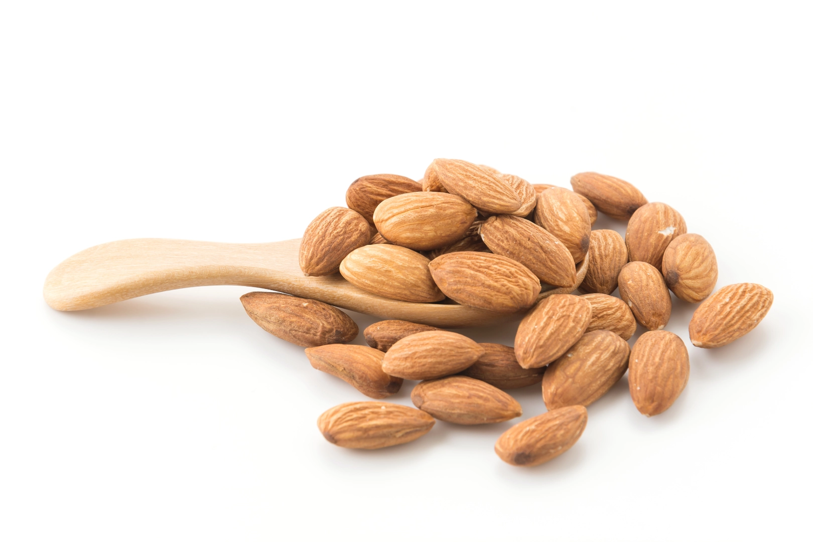 Wooden spoon with scattered raw almonds