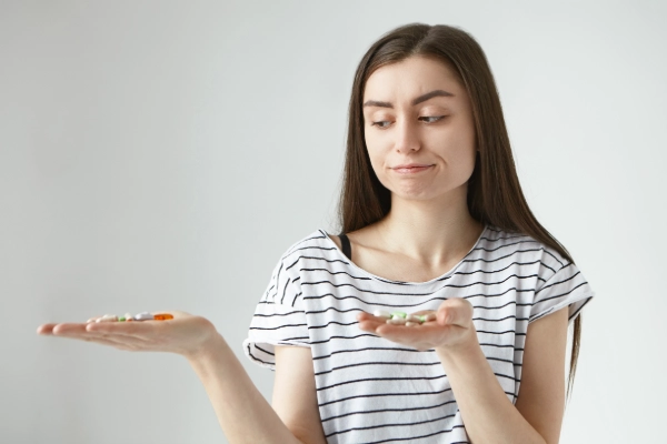 Women with gastroparesis both hands holding pills