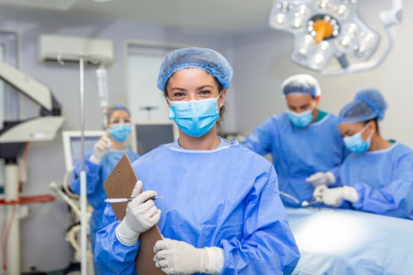 Hiatal hernia surgeon smiling holding clipboard
