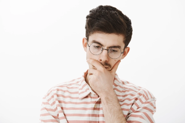 Man with gastroparesis holding chin wondering