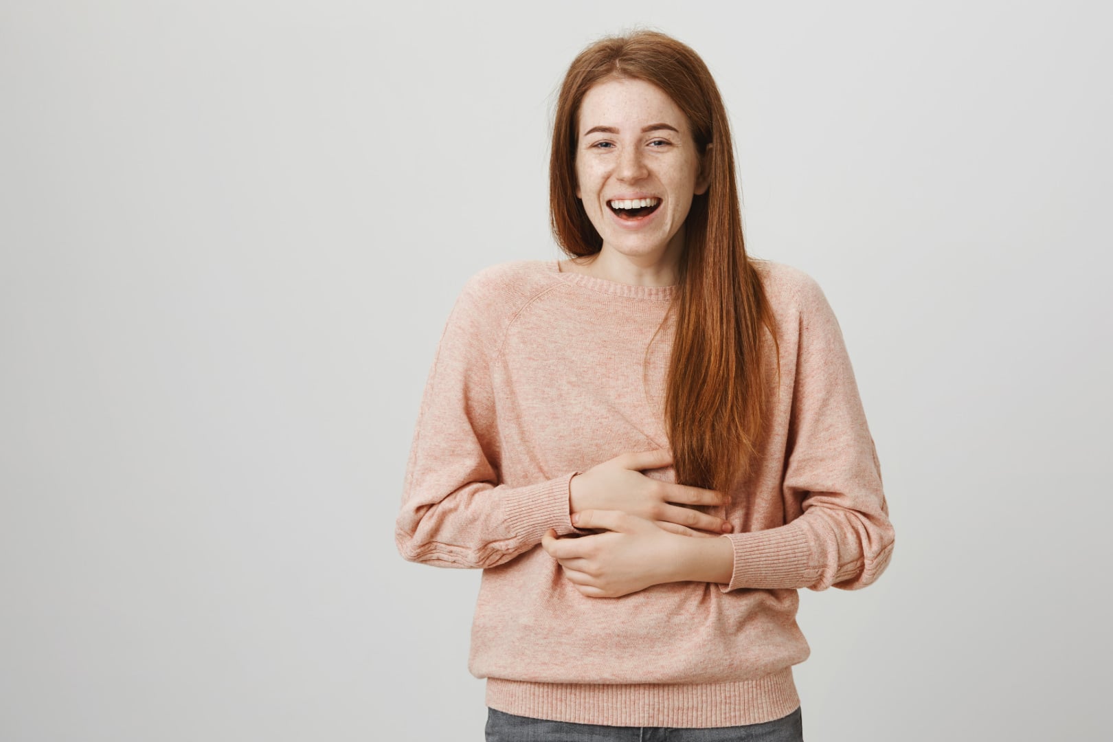 Girl with heartburn touching upper stomach