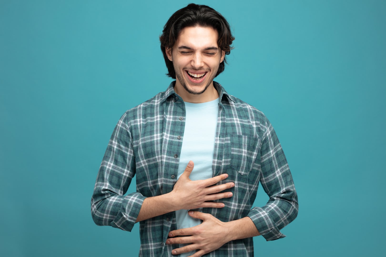 Man with hiatal hernia smiling while holding upper stomach