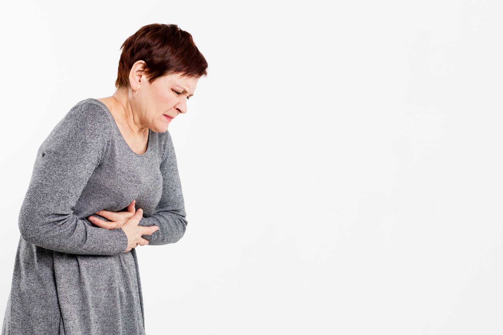 Senior with hiatal hernia holding her chest tightly