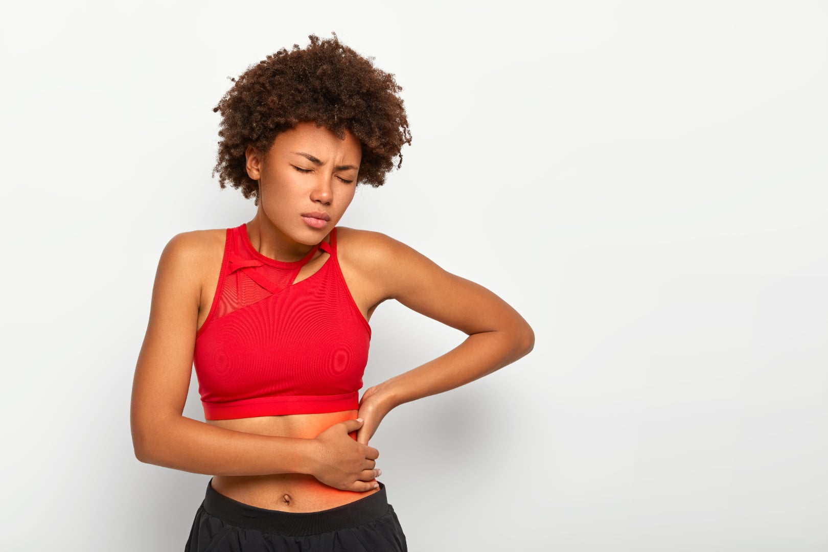 Woman holding side from kidney stone pain