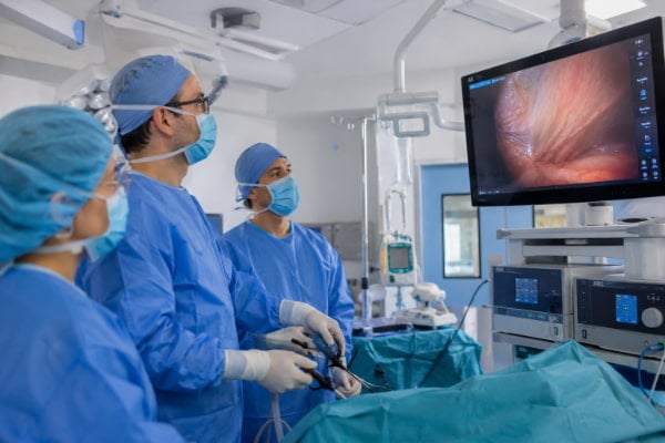 Laparoscopic Nissen fundoplication being performed through small incisions in an operating room