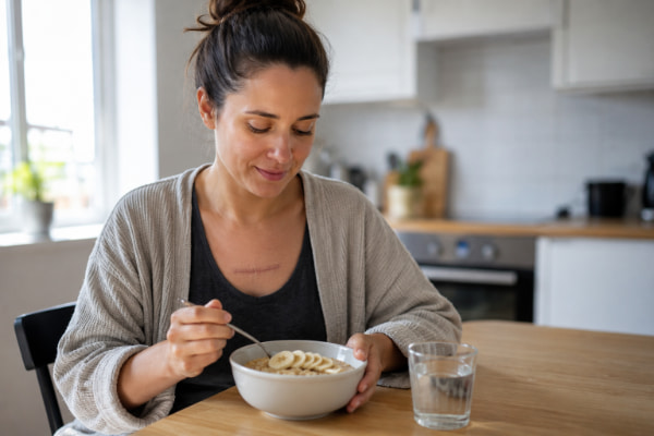 Patient on the soft-food stage of Nissen fundoplication recovery eating at home