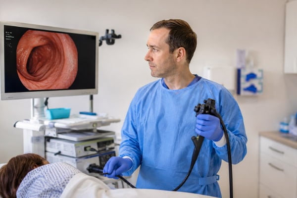 Gastroenterologist performing an upper endoscopy to diagnose gastritis vs GERD
