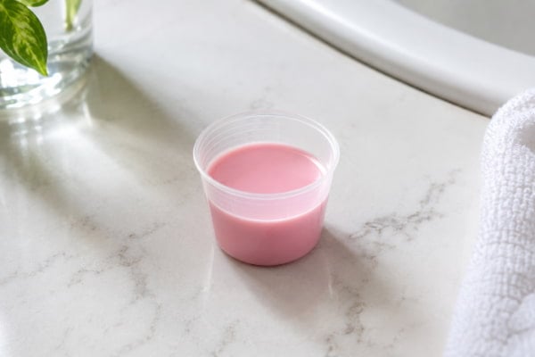 Measured dose of bismuth subsalicylate liquid used for heartburn relief