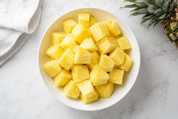 Bowl of diced pineapple, a high-fiber, low-fat source of vitamin C and manganese