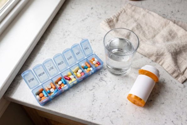 Daily pill organizer showing long-term PPI use linked to esophageal candidiasis risk