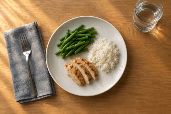 Smaller dinner portion of grilled chicken, green beans, and brown rice to limit evening heartburn