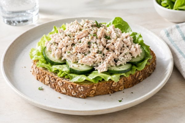 Reflux-friendly tuna sandwich on whole grain bread with cucumber and lettuce